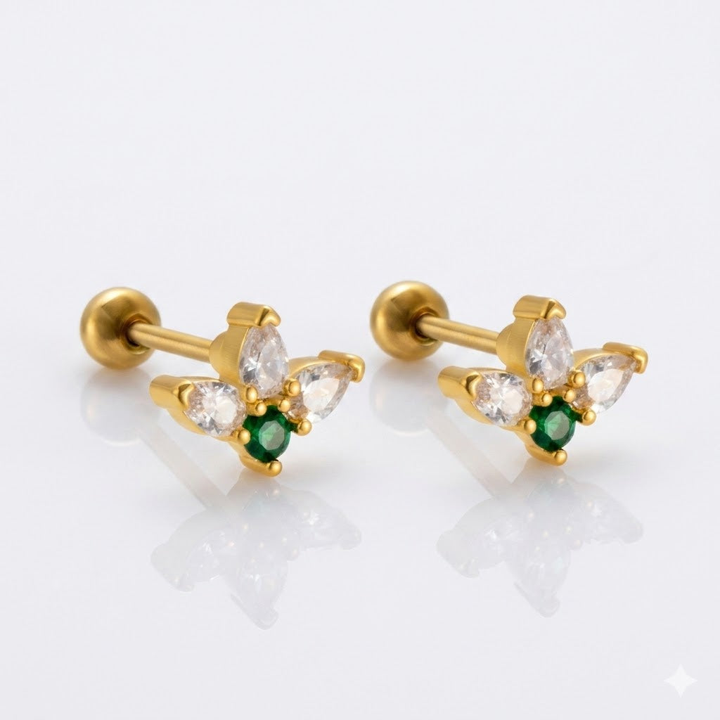 Piercing tres piedras arriba y una verde abajo 🟢